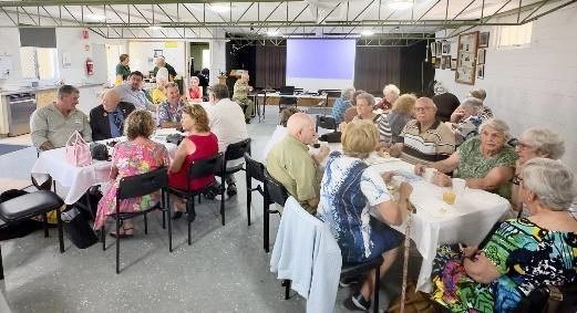 Members seated at tables for the centenary luncheon at Coungeau House