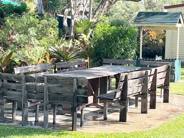 Outdoor table and bench seating in the grounds of Coungeau House
