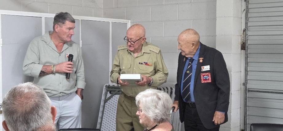 A presentation being made to a member in uniform