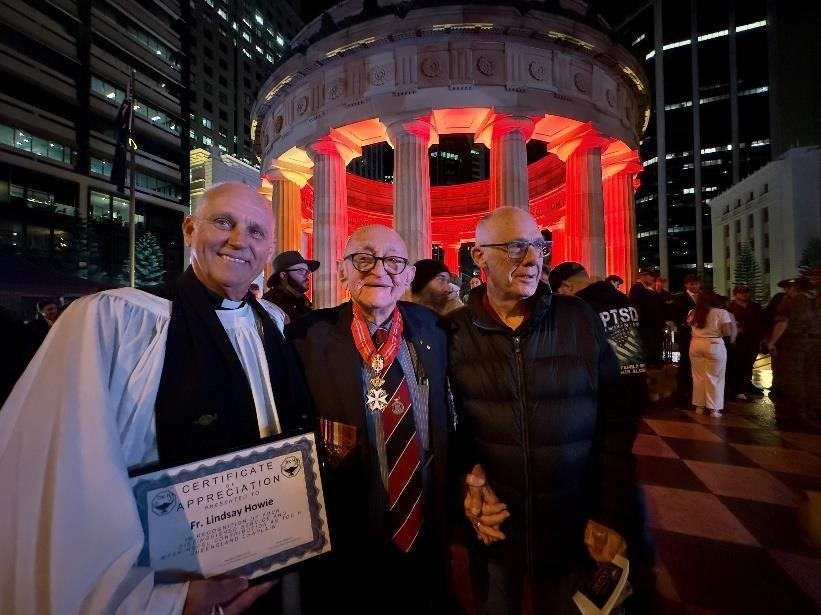 Fr Lindsay Howie being thanked at the ANZAC Midnight Service
