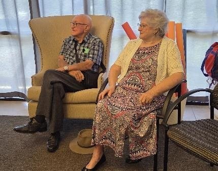 Ray Geise and Jean Lyttle seated, enjoying the concert