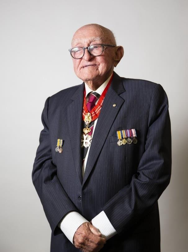 Ray Geise OAM in blazer wearing his medals