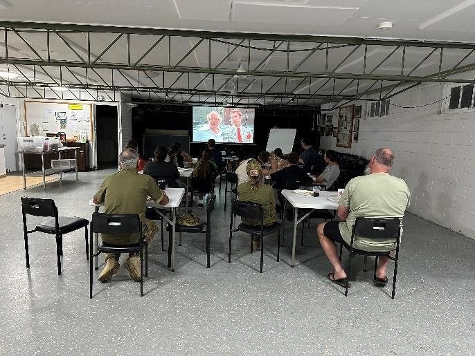 Cadets relaxing at a movie night indoors